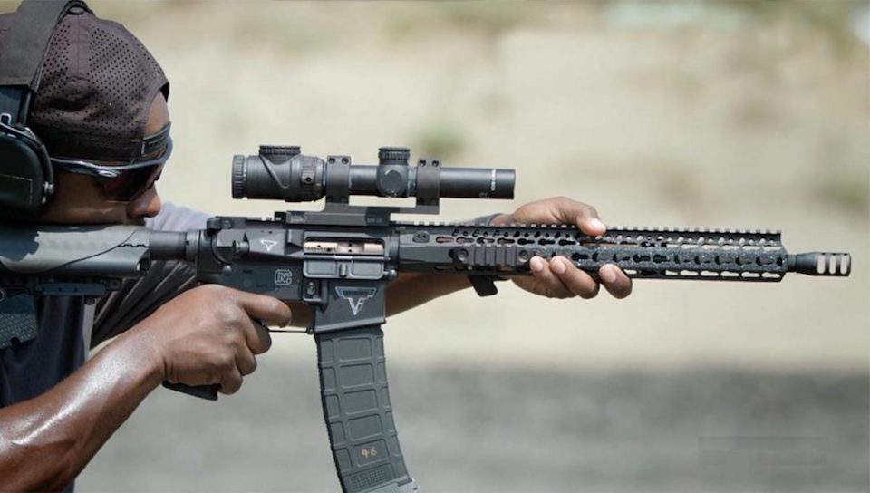 image of a man aiming using an ar-15 scope