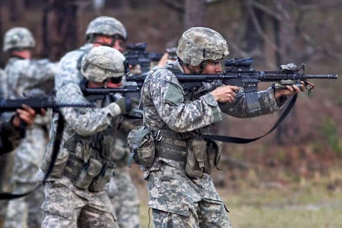 Five army soldiers shooting ar15 rifles at the range during a training exercise