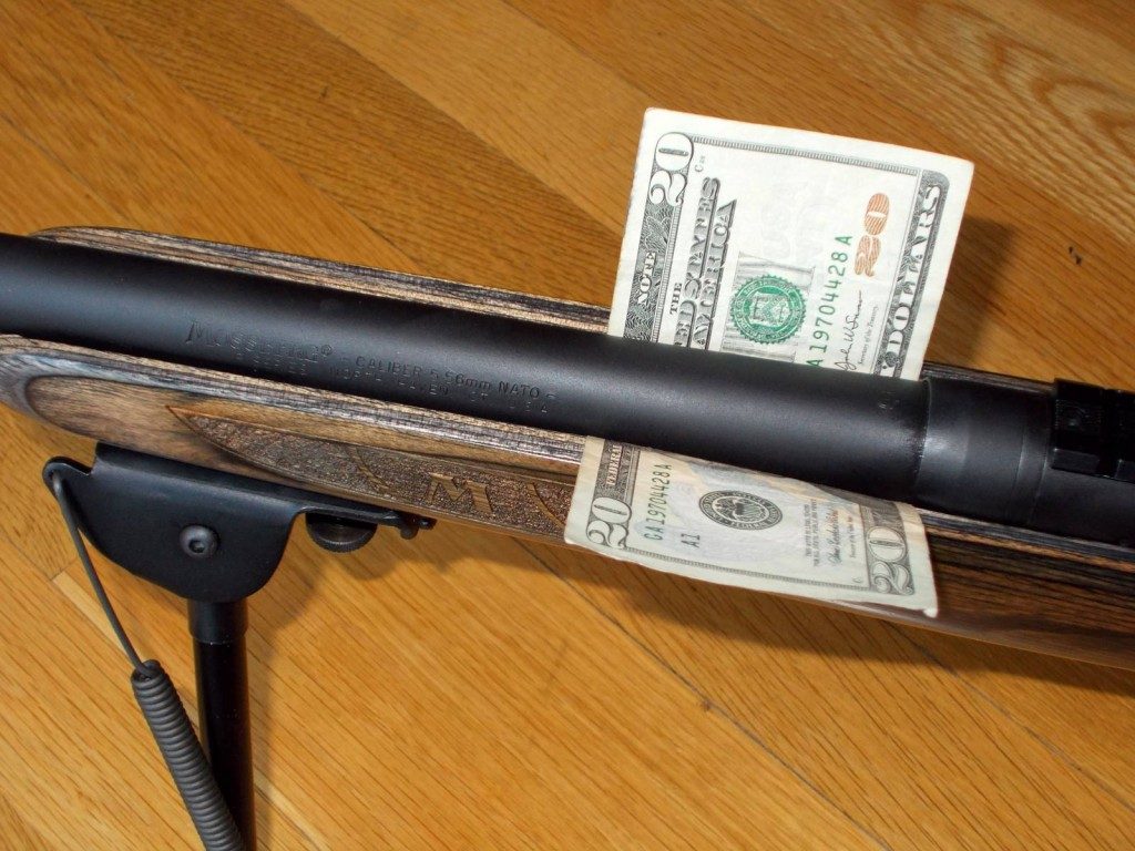close up of a free floating rifle barrel with dollar