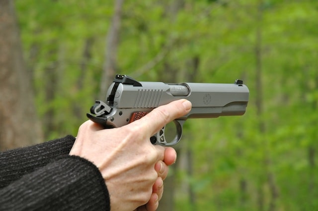 a picture of two hands holding a 1911