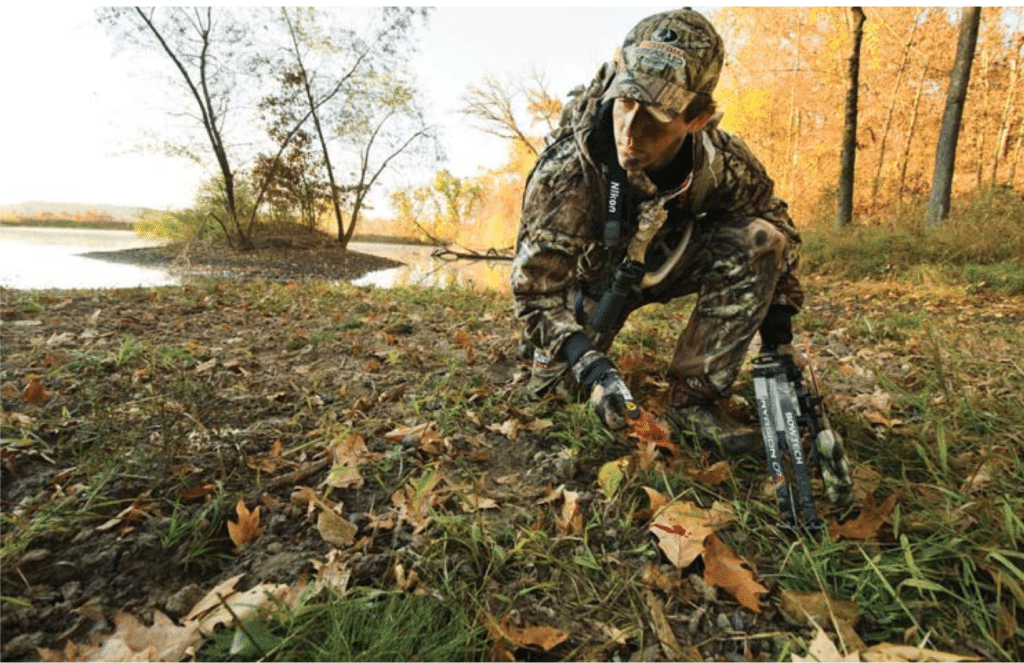 image of a bowhunter tracking for something