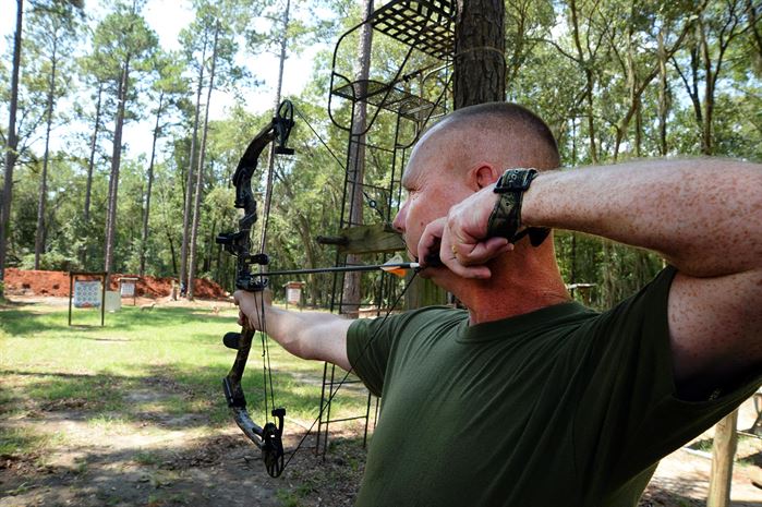 image of a man using a bow hunting sight