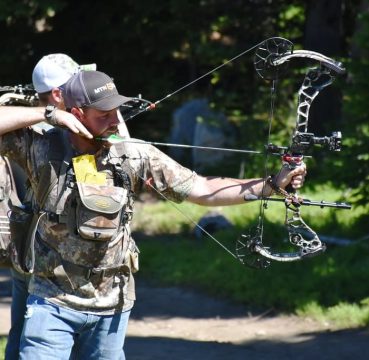 image of a man using his compound bow for hunting