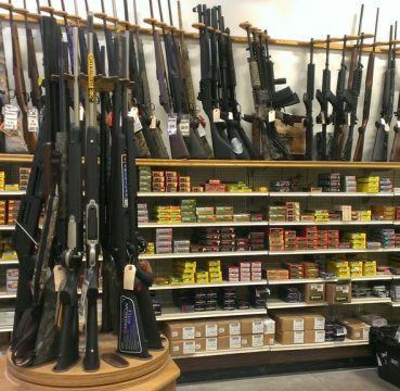 image of rifles and ammunition in a gun store
