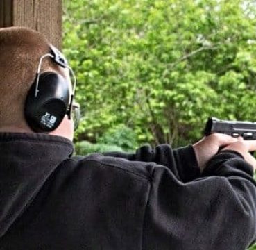 image of a man equipped with Hearing Protection while shooting