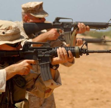 men firing an ar15 rifle