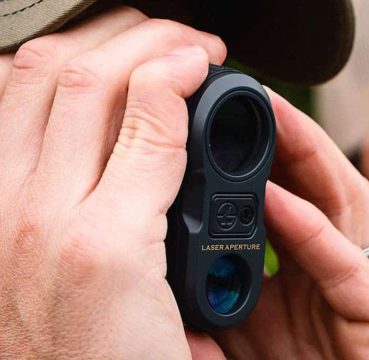 image of a man using rangefinder for bow hunting
