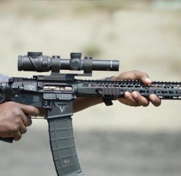image of a man aiming using an ar-15 scope